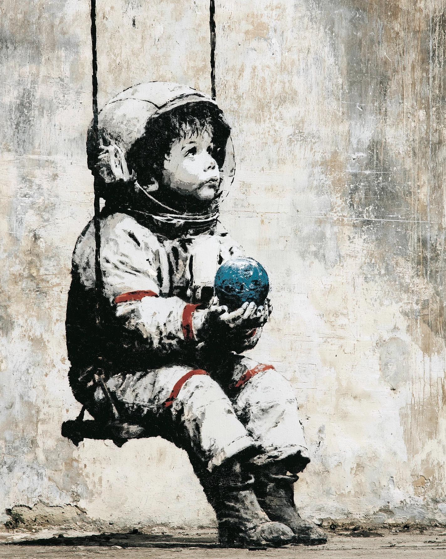 Le Petit Cosmonaute, tableau style Banksy représentant un enfant astronaute assis sur une balançoire tenant la planète Terre dans ses mains en street art au pochoir.